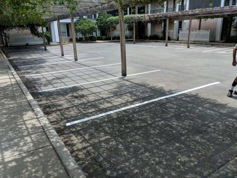 Striping the parking lot of a condo in Fort Walton Beach, FL. parking lot maintenance