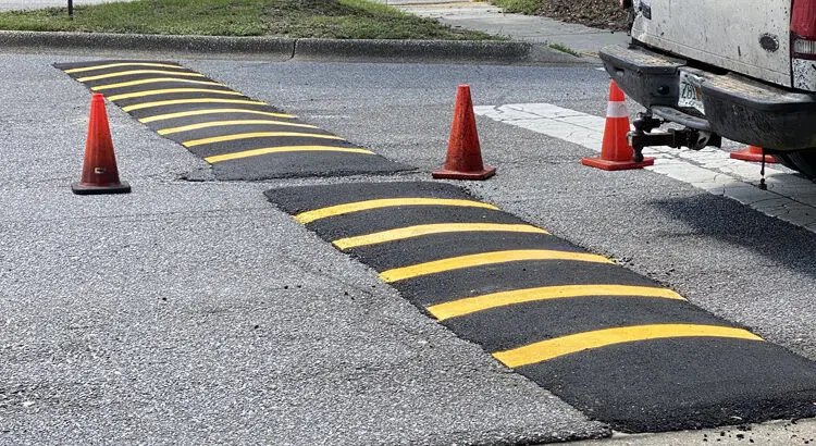 Painted speed bumps and fresh pavement striping in a Pensacola parking lot
