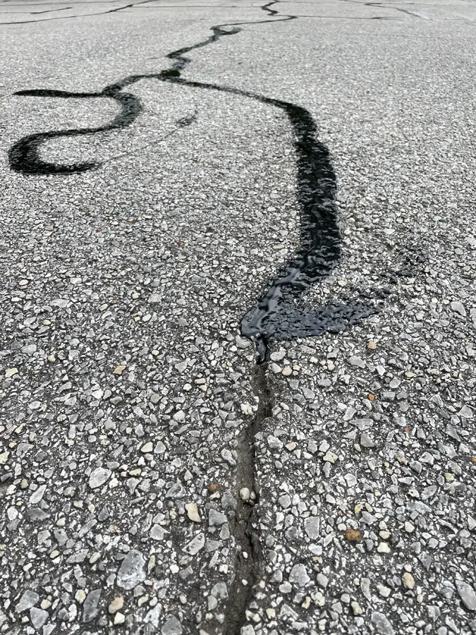 Freshly striped parking lot with bright white and yellow lines and ADA markings during line marking work